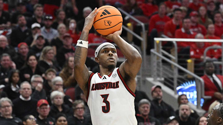 Jan 6, 2026; Louisville, Kentucky, USA;  Louisville Cardinals guard Ryan Conwell (3) shoots against Duke Blue Devils guard Dame Sarr (7) during the second half at KFC Yum! Center. Duke defeated Louisville 84-73. Mandatory Credit: Jamie Rhodes-Imagn Images