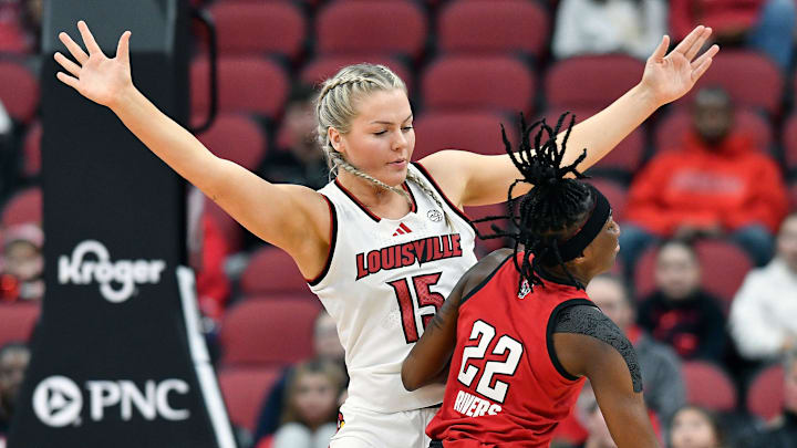 Louisville forward Isla Juffermans (15) blocks NC State guard Saniya Rivers (22) from the lane during the first half of an NCAA college basketball game, Sunday, Dec. 15 2024 in Louisville Ky.