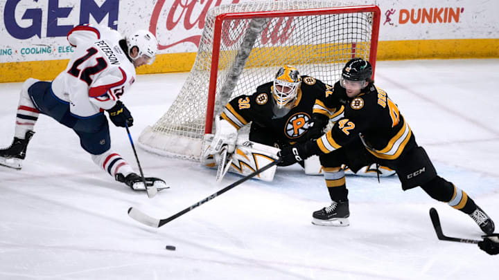 Providence Bruins goalie Michael DiPietro and defender Frederic Brunet deflect the puck from Thunderbird Dylan Peterson away from the Providence goal. Providence Bruins goalie Michael DiPietro and defender Frederic Brunet deflect the puck from Thunderbird Dylan Peterson away from the Providence goal.