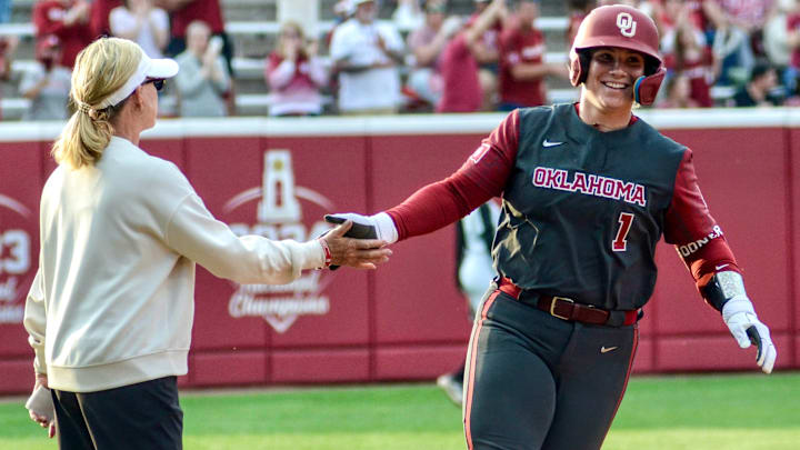 Oklahoma catcher Kendall Wells celebrates a home run with Patty Gasso. Oklahoma catcher Kendall Wells celebrates a home run with Patty Gasso.