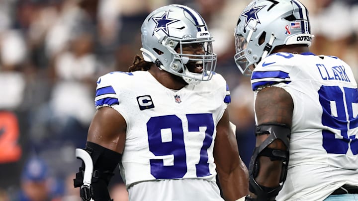 Dallas Cowboys defensive tackle Osa Odighizuwa celebrates with defensive tackle Kenny Clark after a play against the New York Giants during the second quarter at AT&T Stadium. 