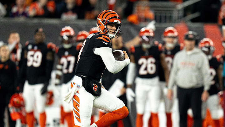 Cincinnati Bengals quarterback Joe Burrow (9) runs for a first down in the third quarter of the NFL game against the Denver Broncos at Paycor Stadium in Cincinnati on Saturday, Dec. 28, 2024.