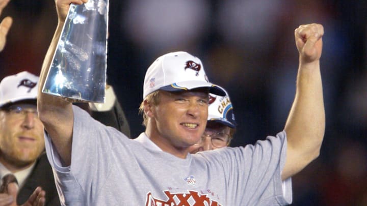 Jon Gruden holds up the Vince Lombardi Trophy after winning Super Bowl XXXVIII against the Oakland Raiders at Qualcomm Stadium in San Diego, CA.