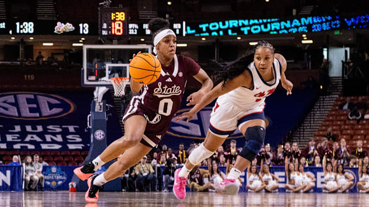 Mar 6, 2025; Greenville, SC, USA; Mississippi State Bulldogs guard Denim DeShields (0) drives by Ole Miss Rebels guard KK Deans (1) during the first half at Bon Secours Wellness Arena. Mandatory Credit: Scott Kinser-Imagn Images
