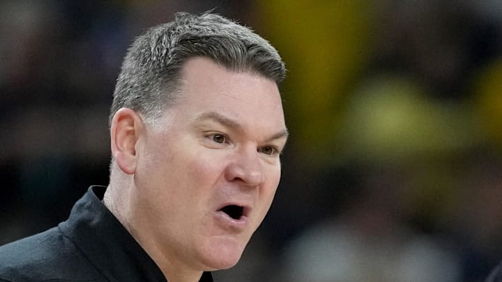 Arizona Wildcats head coach Tommy Lloyd talks with a referee Saturday, April 4, 2026, during a Final Four game against the Michigan Wolverines at Lucas Oil Stadium in Indianapolis.