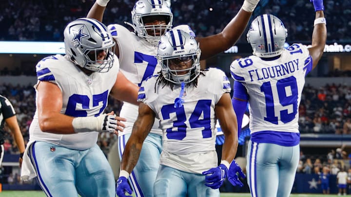 Teammates celebrate with Dallas Cowboys running back Jaydon Blue after he scores a touchdown against the Atlanta Falcons 