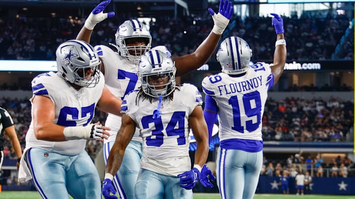 Teammates celebrate with Dallas Cowboys running back Jaydon Blue after he scores a touchdown against the Atlanta Falcons 