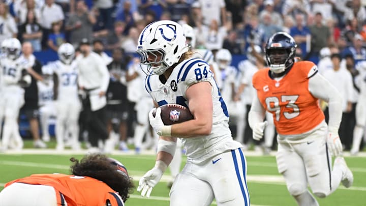 Sep 14, 2025; Indianapolis, Indiana, USA; Indianapolis Colts tight end Tyler Warren (84) runs with the ball during the second quarter against the Denver Broncos at Lucas Oil Stadium. 