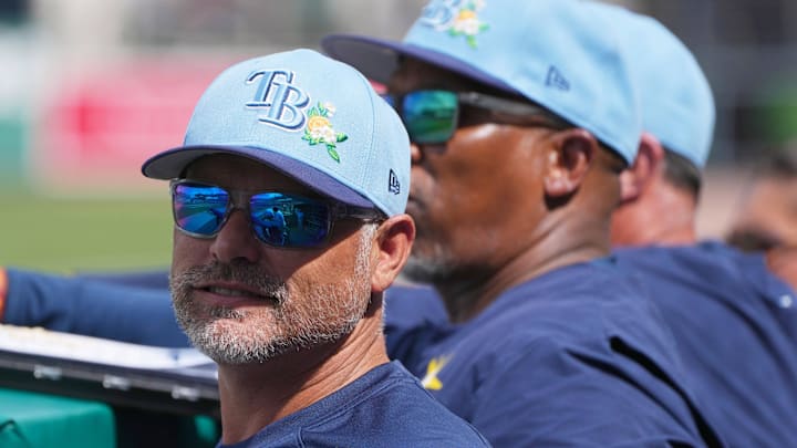 Feb 26, 2026; Fort Myers, Florida, USA; Tampa Bay Rays manager Kevin Cash looks on from the dugout during the fourth inning against the Boston Red Sox at JetBlue Park at Fenway South. 