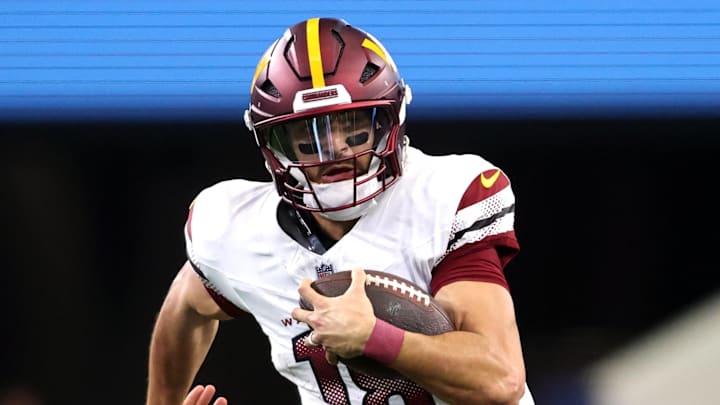 Washington Commanders quarterback Marcus Mariota runs for a first down against the Dallas Cowboys.