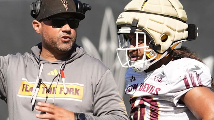 Arizona State linebackers coach A.J. Cooper talks to linebacker Zyrus Fiaseu (30) during practice on March 24, 2026, at Kajikawa Practice Fields in Tempe.