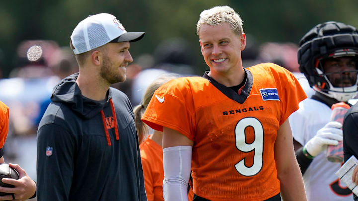 Cincinnati Bengals quarterback Joe Burrow (9) talks with quarterback Jake Browning during a preseason joint practice at the Paycor Stadium practice facility in downtown Cincinnati on Tuesday, Aug. 20, 2024.