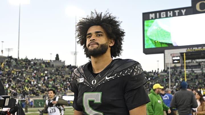 Nov 22, 2025; Eugene, Oregon, USA; Oregon Ducks quarterback Dante Moore (5) walks off the field after the game against the Southern California Trojans at Autzen Stadium. Mandatory Credit: Troy Wayrynen-Imagn Images