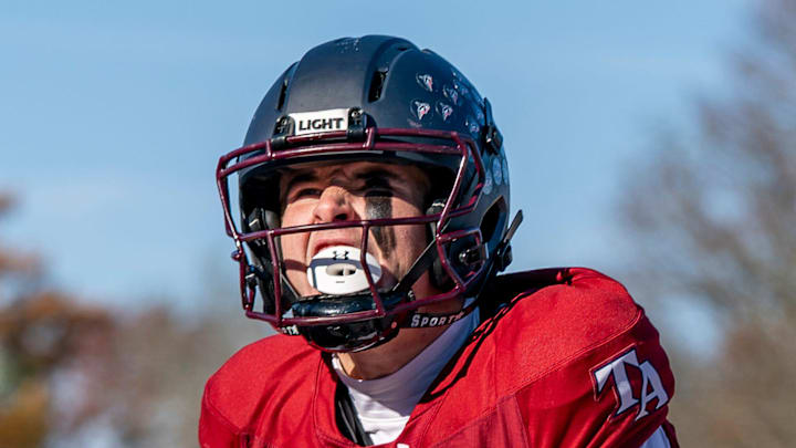 Tabor Academy quarterback Peter Bourque celebrates after scoring a touchdown in the opening drive.