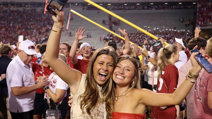 Arkansas Razorbacks fans celebrate in front of the downed goal posts after the game against the Tennessee Volunteers at Razorback Stadium.