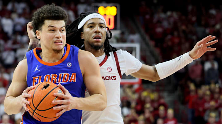 Florida Gators guard Walter Clayton Jr. (1) drives against Arkansas Razorbacks guard Boogie Fland (2) during the second half at Bud Walton Arena. Florida won 71-63. 
