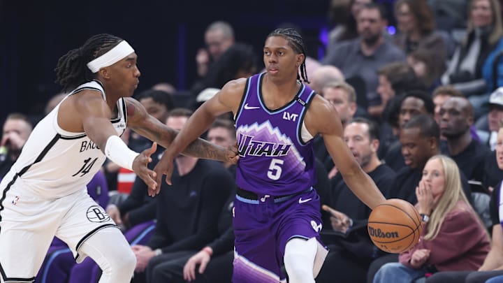 Jan 30, 2026; Salt Lake City, Utah, USA; Utah Jazz forward Cody Williams (5) dribbles against Brooklyn Nets guard Terance Mann (14) during the first half at Delta Center. Mandatory Credit: Rob Gray-Imagn Images
