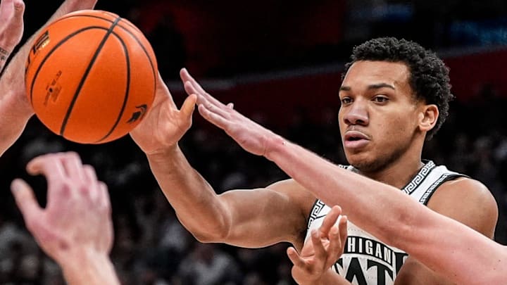 Michigan State guard Divine Ugochukwu (99) makes a pas against Oakland guard Brody Robinson (55) during the second half at Little Caesars Arena in Detroit on Saturday, Dec. 20, 2025.