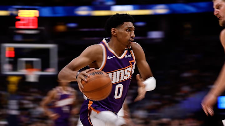 Oct 13, 2024; Denver, Colorado, USA; Phoenix Suns forward Ryan Dunn (0) controls the ball as Denver Nuggets center Nikola Jokic (15) defends in the second quarter at Ball Arena. Mandatory Credit: Isaiah J. Downing-Imagn Images