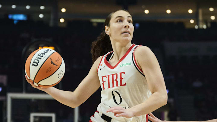 May 12, 2026; Portland, Oregon, USA; Portland Fire guard Carla Leite (0) drives to the basket during the first half against New York Liberty guard Pauline Astier (18) with help from center Luisa Geiselsoder (15) at Moda Center. Mandatory Credit: Troy Wayrynen-Imagn Images