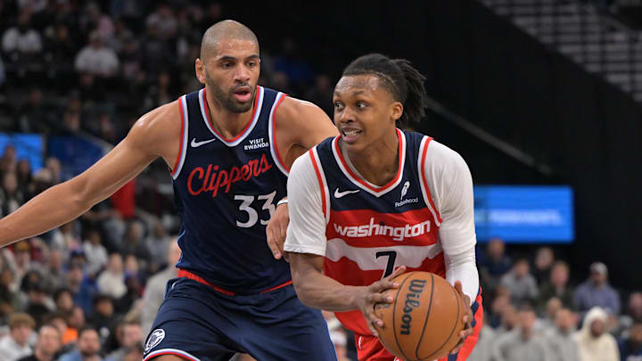 Jan 14, 2026; Inglewood, California, USA; Los Angeles Clippers forward Nicolas Batum (33) defends Washington Wizards guard Bub Carrington (7) as he drives to the basket in the second half at Intuit Dome. Mandatory Credit: Jayne Kamin-Oncea-Imagn Images