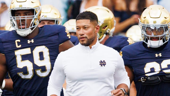 Notre Dame head coach Marcus Freeman, center, takes the field with his team before a NCAA football game against Purdue at Notre Dame Stadium on Saturday, Sept. 20, 2025, in South Bend.