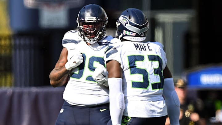 Sep 15, 2024; Foxborough, Massachusetts, USA;  Seattle Seahawks defensive end Leonard Williams (99) reacts with linebacker Boye Mafe (53) after a sack against New England Patriots quarterback Jacoby Brissett (7) during the second half at Gillette Stadium. Mandatory Credit: Brian Fluharty-Imagn Images