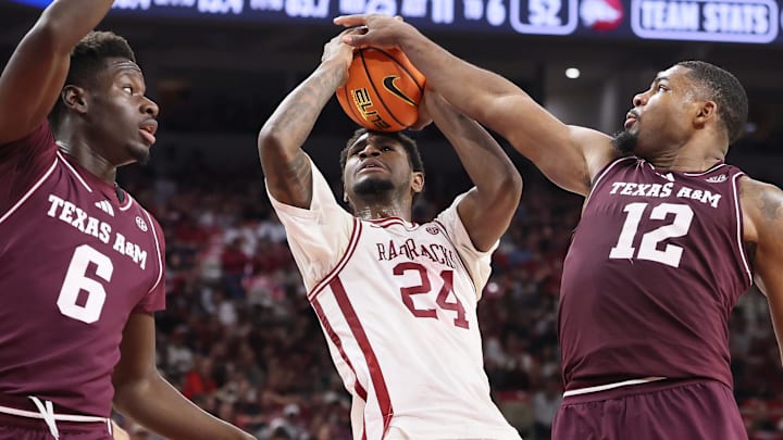 Arkansas Razorbacks wing Billy Richmond III (24) is fouled while shooting by Texas A&M Aggies forward Rashaun Agee (12) as guard Ali Dibba (6) looks on during the second half at Bud Walton Arena in Fayetteville, Ark. Arkansas Razorbacks wing Billy Richmond III (24) is fouled while shooting by Texas A&M Aggies forward Rashaun Agee (12) as guard Ali Dibba (6) looks on during the second half at Bud Walton Arena in Fayetteville, Ark.