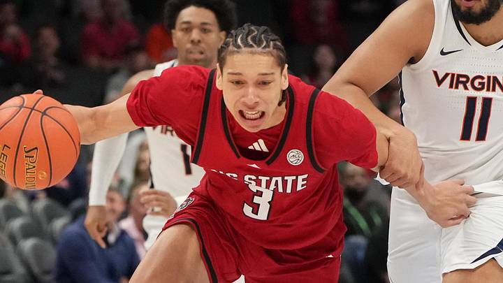 Mar 12, 2026; Charlotte, NC, USA; NC State Wolfpack guard Matt Able (3) and Virginia Cavaliers forward Devin Tillis (11) fight for the ball in the first half at Spectrum Center. Mandatory Credit: Bob Donnan-Imagn Images