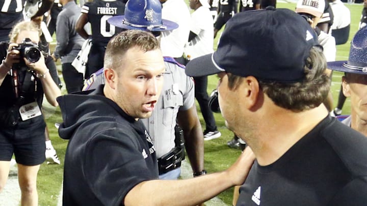 Sep 6, 2025; Starkville, Mississippi, USA; Arizona State Sun Devils head coach Kenny Dillingham (left) and Mississippi State Bulldogs head coach Jeff Lebby (right) meet at mid-field after the game at Davis Wade Stadium at Scott Field. Mandatory Credit: Petre Thomas-Imagn Images
