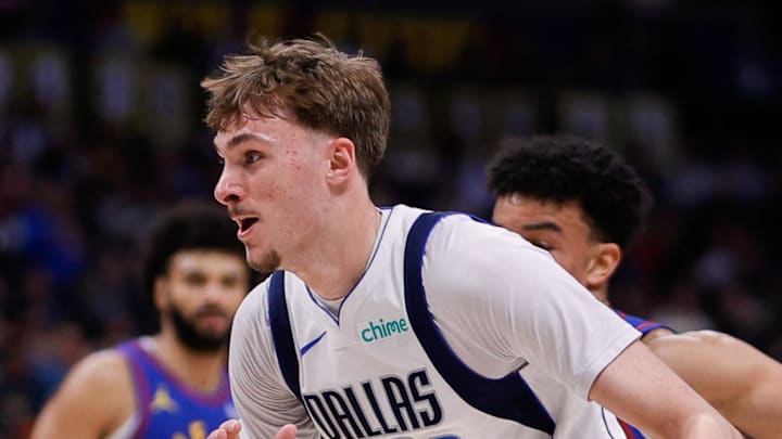 Dallas Mavericks forward Cooper Flagg controls the ball ahead of Denver Nuggets forward Spencer Jones.
