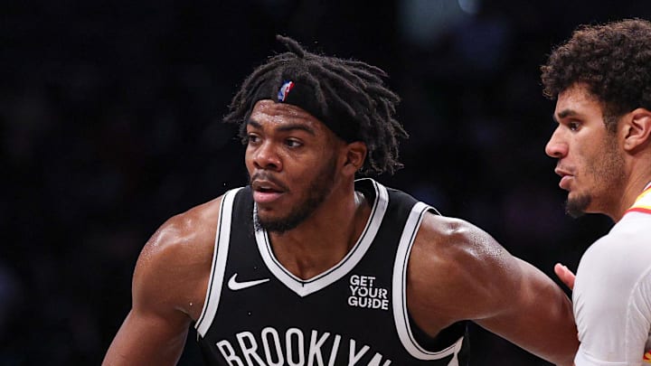 Mar 16, 2025; Brooklyn, New York, USA; Brooklyn Nets center Day'Ron Sharpe (20) is defended by Atlanta Hawks forward Dominick Barlow (0) during the second half at Barclays Center. Mandatory Credit: Vincent Carchietta-Imagn Images