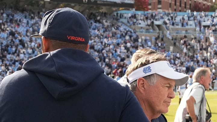 Oct 25, 2025; Chapel Hill, North Carolina, USA; North Carolina Tar Heels head coach Bill Belichick shakes Virginia Cavaliers head coach Tony Elliott hand after the Tar Heels lose to Virginia in overtime at Kenan Stadium. Mandatory Credit: Bob Donnan-Imagn Images Oct 25, 2025; Chapel Hill, North Carolina, USA; North Carolina Tar Heels head coach Bill Belichick shakes Virginia Cavaliers head coach Tony Elliott hand after the Tar Heels lose to Virginia in overtime at Kenan Stadium. Mandatory Credit: Bob Donnan-Imagn Images
