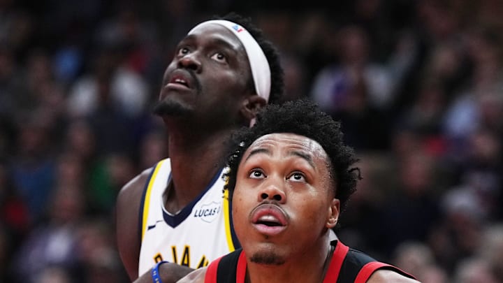 Indiana Pacers forward Pascal Siakam battles for the round with Toronto Raptors forward Scottie Barnes.