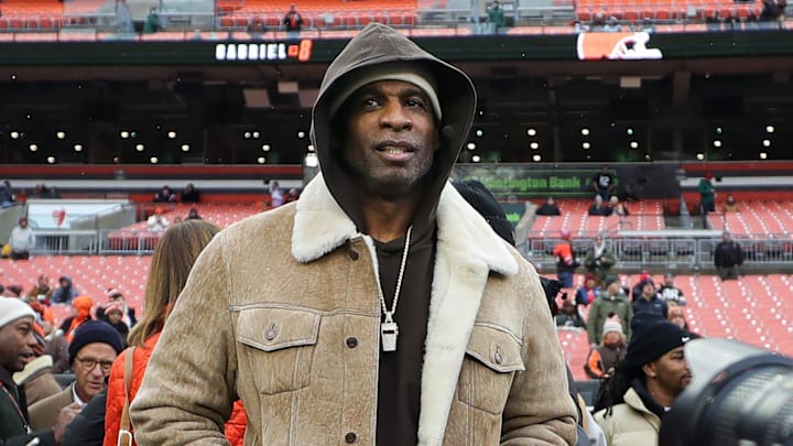 NFL legend Deion Sanders tries to keep a low profile as photographers swarm his on the sideline before an NFL football game at Huntington Bank Field, Dec. 7, 2025, in Cleveland, Ohio. NFL legend Deion Sanders tries to keep a low profile as photographers swarm his on the sideline before an NFL football game at Huntington Bank Field, Dec. 7, 2025, in Cleveland, Ohio.