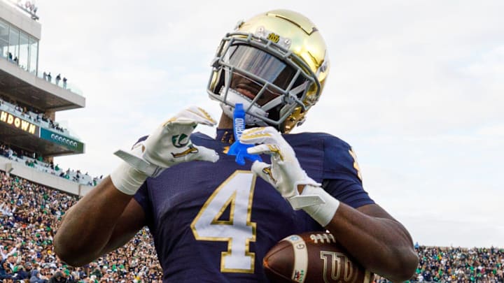 Notre Dame running back Jeremiyah Love (4) makes a heart sign after scoring a touchdown in the first half of a NCAA football game against Syracuse at Notre Dame Stadium on Saturday, Nov. 22, 2025, in South Bend.