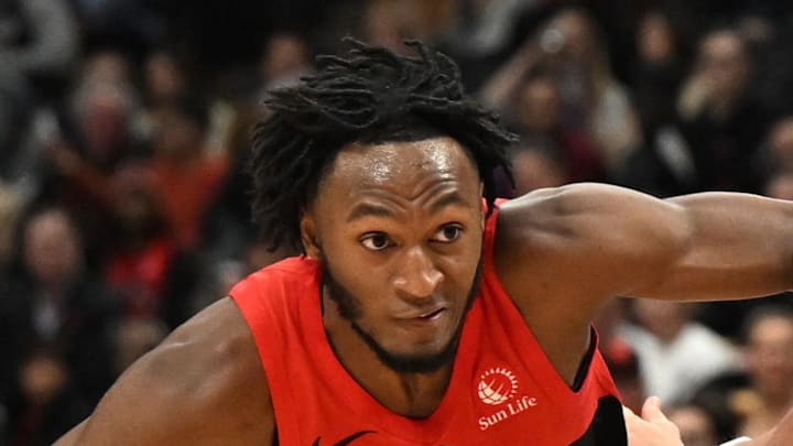 Toronto Raptors guard Immanuel Quickley dribbles past Chicago Bulls guard Mac McClung.