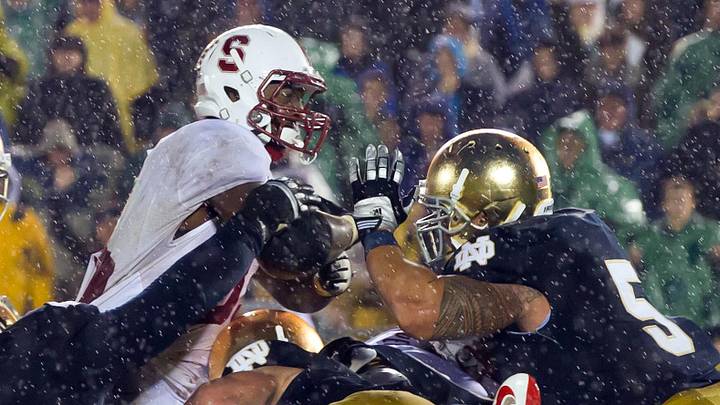 Oct. 13, 2012; South Bend, IN, USA; Stanford Cardinal running back Stepfan Taylor (33) attempts to dive over the goal line as Notre Dame Fighting Irish nose guard Louis Nix (9) and linebacker Manti Te'o (5) defend in overtime at Notre Dame Stadium. Notre Dame won 20-13. Oct. 13, 2012; South Bend, IN, USA; Stanford Cardinal running back Stepfan Taylor (33) attempts to dive over the goal line as Notre Dame Fighting Irish nose guard Louis Nix (9) and linebacker Manti Te'o (5) defend in overtime at Notre Dame Stadium. Notre Dame won 20-13.