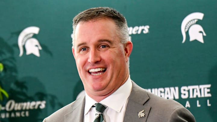 Michigan State's new football coach Pat Fitzgerald talks during his introductory press conference on Tuesday, Dec. 2, 2025, at the Tom Izzo Football Building in East Lansing. MSU athletic director J Batt, center, and MSU president Kevin Guskiewicz, left, look on.