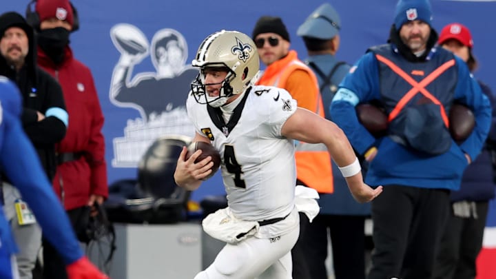 Dec 8, 2024; East Rutherford, New Jersey, USA; New Orleans Saints quarterback Derek Carr (4) runs with the ball against the New York Giants during the fourth quarter at MetLife Stadium. Mandatory Credit: Brad Penner-Imagn Images