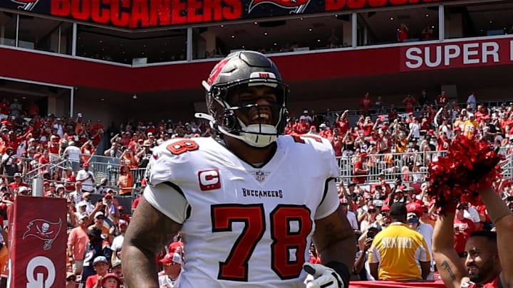 Tampa Bay Buccaneers quarterback Baker Mayfield and offensive tackle Tristan Wirfs take the field for a game against the Denver Broncos.