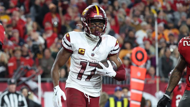 Jan 12, 2025; Tampa, Florida, USA; Washington Commanders wide receiver Terry McLaurin (17) reacts after catching a touchdown against Tampa Bay Buccaneers safety Josh Hayes (32) during the fourth quarter of a NFC wild card playoff at Raymond James Stadium. Mandatory Credit: Kim Klement Neitzel-Imagn Images