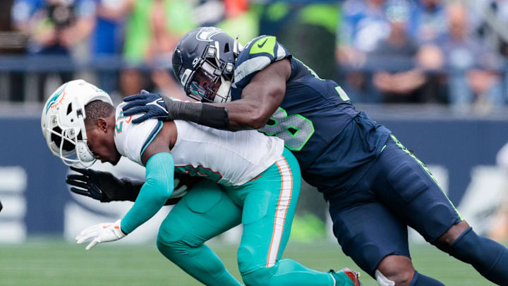 Sep 22, 2024; Seattle, Washington, USA; Seattle Seahawks linebacker Derick Hall makes a tackle against the Miami Dolphins at Lumen Field. Mandatory Credit: Kevin Ng-Imagn Images Sep 22, 2024; Seattle, Washington, USA; Seattle Seahawks linebacker Derick Hall makes a tackle against the Miami Dolphins at Lumen Field. Mandatory Credit: Kevin Ng-Imagn Images