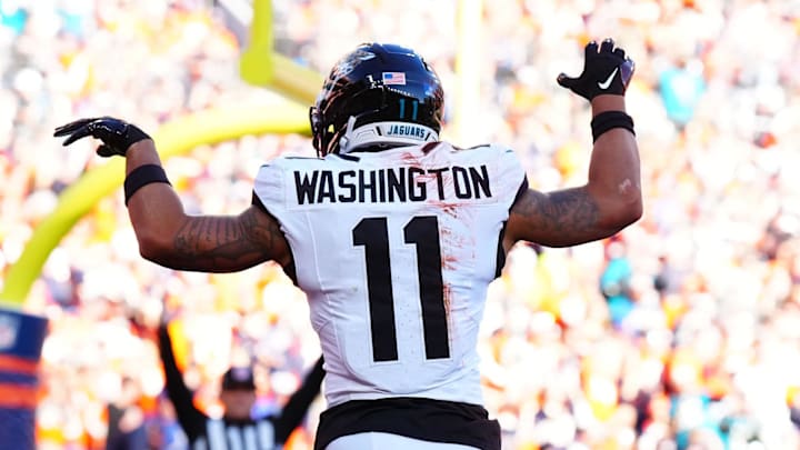 Dec 21, 2025; Denver, Colorado, USA; Jacksonville Jaguars wide receiver Parker Washington (11) reacts after making a touchdown catch against the Denver Broncos during the first half at Empower Field at Mile High. Mandatory Credit: Ron Chenoy-Imagn Images