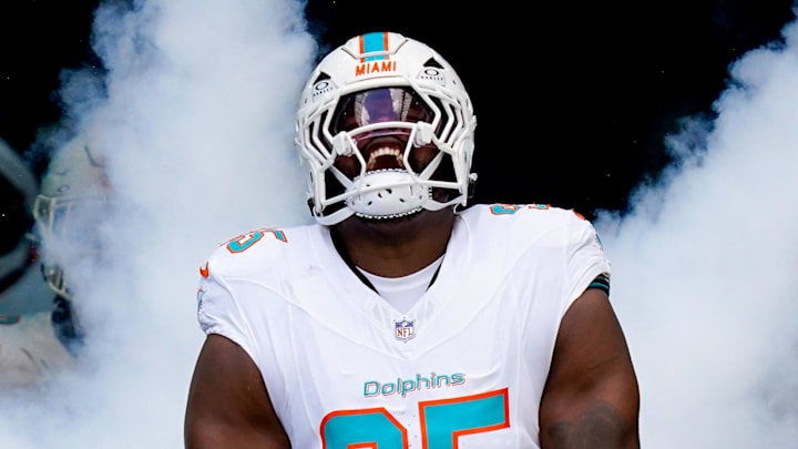 Former Miami Dolphins defensive tackle Benito Jones runs on the field.