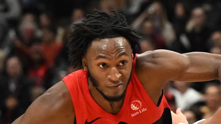 Toronto Raptors guard Immanuel Quickley dribbles past Chicago Bulls guard Mac McClung.