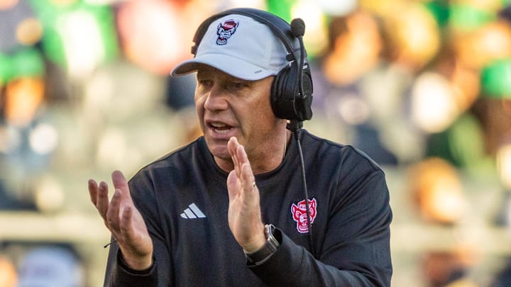 Oct 11, 2025; South Bend, Indiana, USA; NC State Wolfpack head coach Dave Doeren claps as he walks onto the field against the Notre Dame Fighting Irish during the second half at Notre Dame Stadium. Mandatory Credit: Michael Caterina-Imagn Images