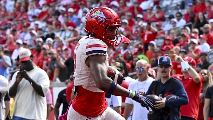 Oct 18, 2025; Houston, Texas, USA; Arizona Wildcats wide receiver Tre Spivey (12) runs the ball in for a touchdown during the fourth quarter against the Houston Cougars at TDECU Stadium. Mandatory Credit: Maria Lysaker-Imagn Images 