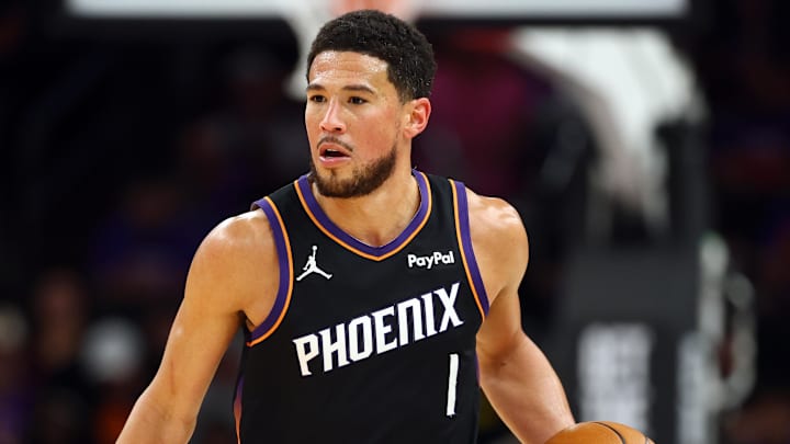 Apr 17, 2026; Phoenix, Arizona, USA; Phoenix Suns guard Devin Booker (1) against the Golden State Warriors during the play-in rounds of the 2026 NBA Playoffs at Mortgage Matchup Center. Mandatory Credit: Mark J. Rebilas-Imagn Images