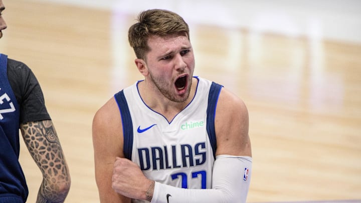 Dec 17, 2020; Dallas, Texas, USA; Dallas Mavericks guard Luka Doncic (77) yells at the referees as Minnesota Timberwolves forward Juan Hernangomez (41) defends during the first quarter at the American Airlines Center. Mandatory Credit: Jerome Miron-Imagn Images